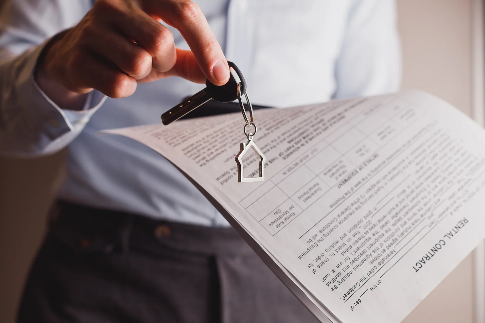 A property manager handing over keys with the lease